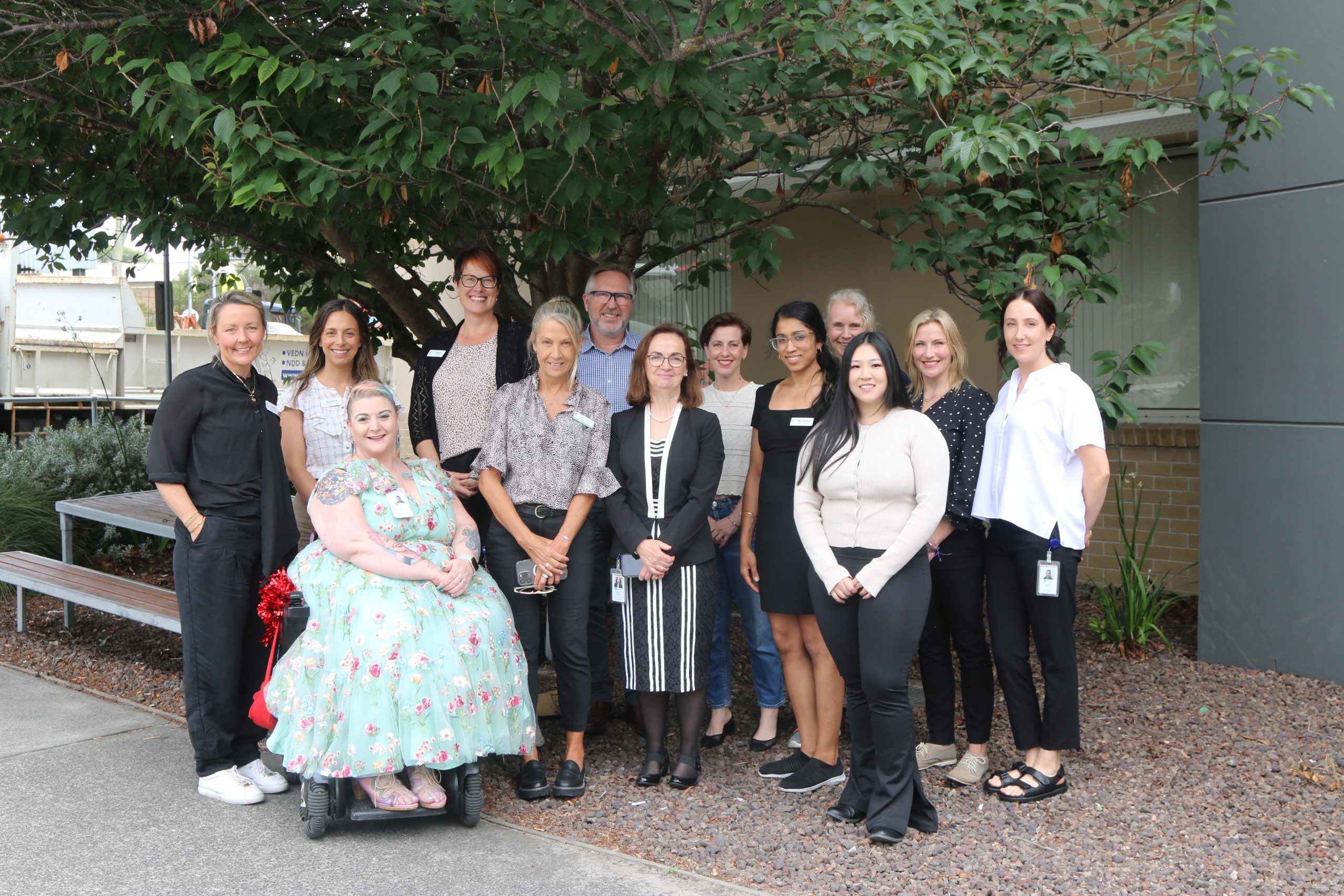 Group of Peninsula Health team members stand in group outside to celebrate International Day of People with a Disability.